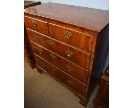 Early 18th century style walnut chest cross banded top over two short and three full width graduated drawers on bracket feet,