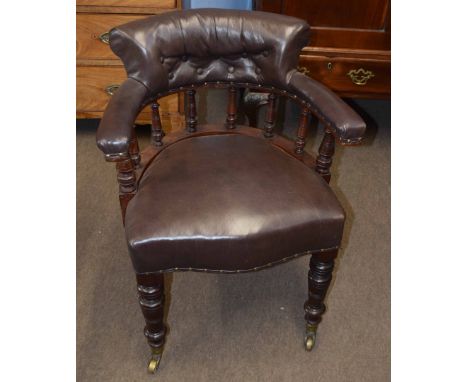 Late 19th century mahogany framed desk tub chair, upholstered in brown leather button back raised on ring turned front suppor