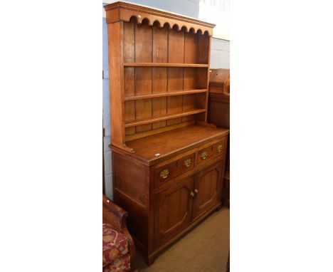 Oak small dresser, plate rack back, lower section with two drawers and cupboard below on bracket feet 120cm wide 