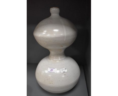 A vintage stone ware studio pottery vessel or lamp base with white glaze and gourd design