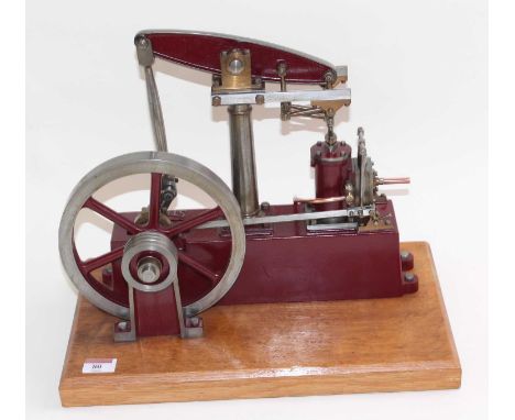 A Stuart Turner stationery beam engine comprising of maroon body with vertical single cylinder engine with steam and exhaust 