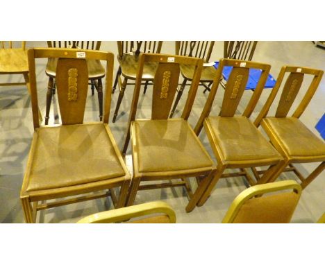 Pair of dark oak Ercol dining chairs with carvings to back