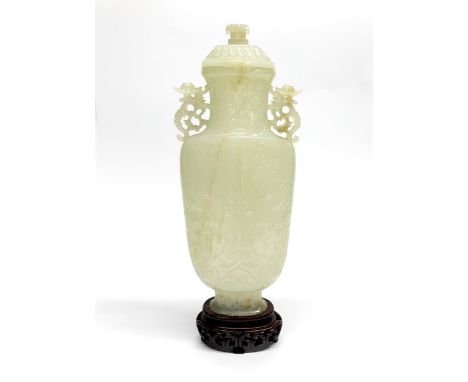 A superb Chinese finely carved nephrite jade vase and cover with carved wooden stand, overall H. 26cm.