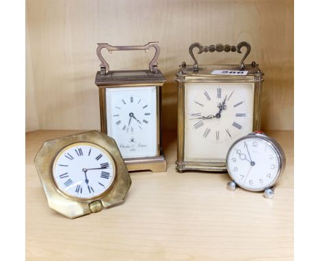 Two brass carriage clocks, a brass travelling clock and a vintage alarm clock.