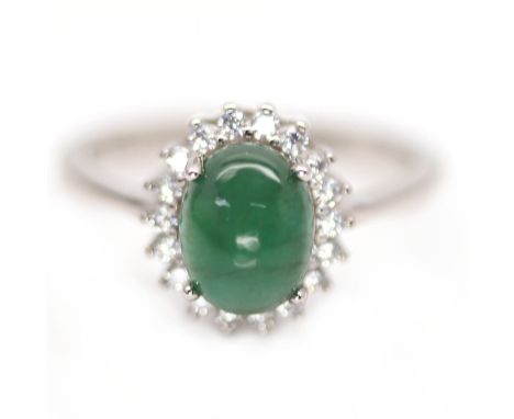 A 925 silver cluster ring set with a cabochon cut emerald surrounded by white stones, (P).