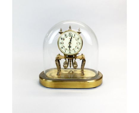 A Kuma mantel clock under glass dome, H.23cm W. 22cm.