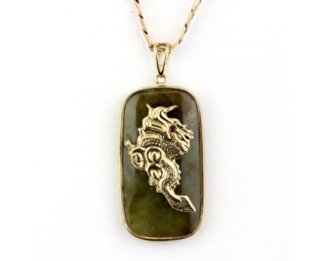 A hallmarked 9ct yellow gold jade set pendant of a dragon with a ruby eye and Chinese characters, L. 4cm, on a hallmarked 9ct