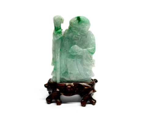 A Chinese carved jade figure of Shou Lao with carved wooden stand, overall H. 9cm.