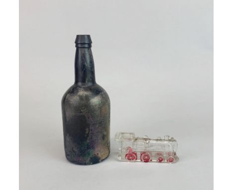 An early glass bottle with an American glass railway engine, bottle H. 24cm.