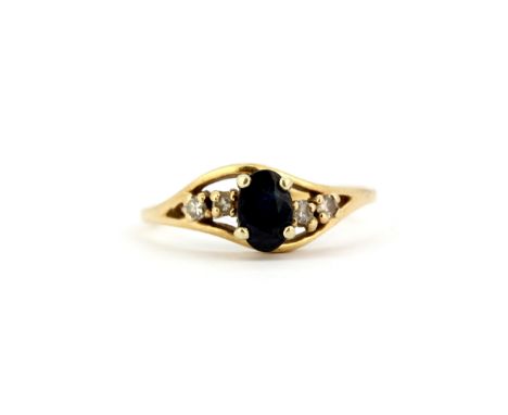 A 9ct yellow gold (stamped 9K) ring set with an oval cut sapphire and diamonds, (K.5).