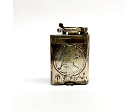 An early 20th C handmade white metal lighter (probably Egyptian) inset with an Austrian 1780 silver coin, H. 7cm.