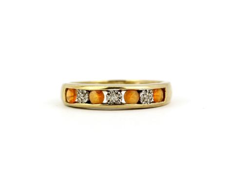 A hallmarked 9ct yellow gold half eternity ring set round cut orange stones and diamonds, (P.5).