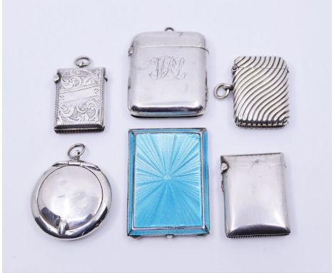 A blue guilloche enamel silver match case, together with a silver circular compact and four further silver vesta cases&nbsp;