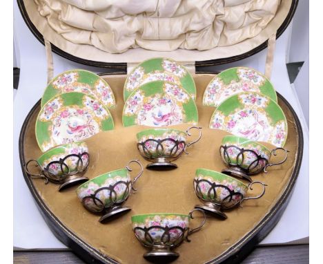 A cabinet set of porcelain cups and saucers mounted in silver&nbsp;