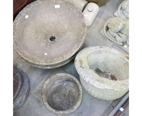 Three concrete bird baths and a planter 