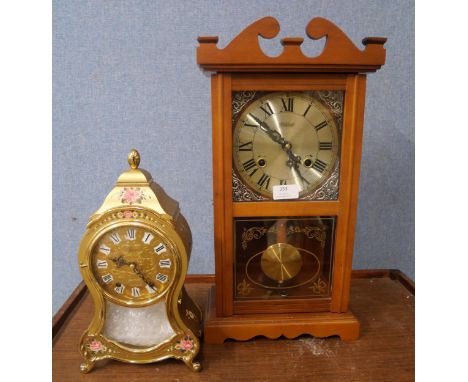 A Highlands chiming wall clock and an Eluxa gold and floral clock with wall bracket 