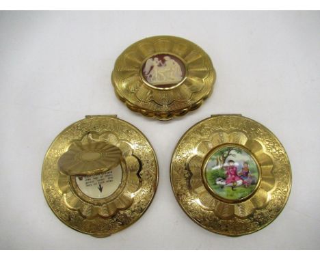 KIGU gilt circular engine turned compacts, one with cameo cover, one with hinged portrait cover and another with hand painted