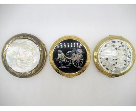 Circular Compact with Pagoda and mountain scene carved into mother of Pearl to front, another circular compact with man pulli