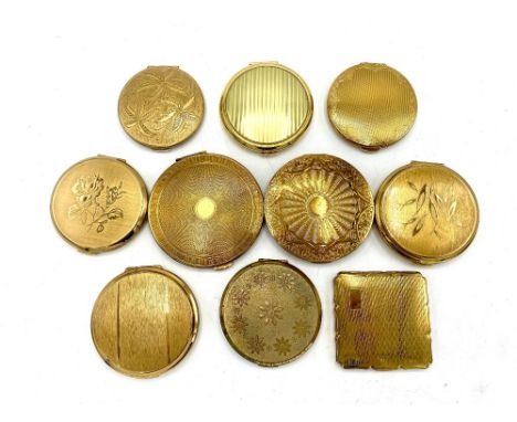 Seven Stratton compacts with engine turned, etched and relief covers, two Kigu compacts with engine turned covers and one unk