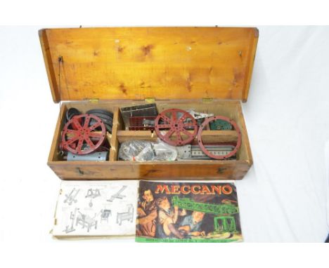 Wooden chest containing a large amount of vintage meccano with instructions, electric motor, wheels, clockwork motors with ke