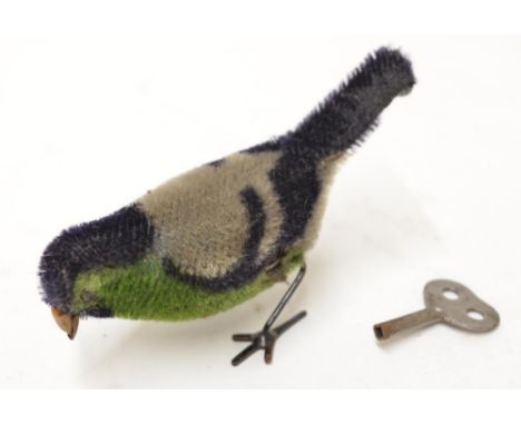 Vintage wind up mechanical bird with key. 