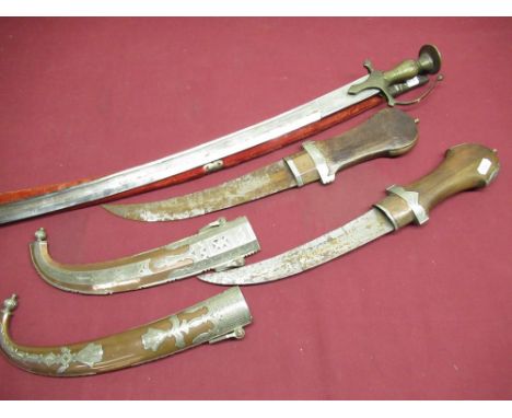 Indian tulwar type sword with scabbard, two large Indo Persian daggars with carved wood handles, semi curved blades and ornat