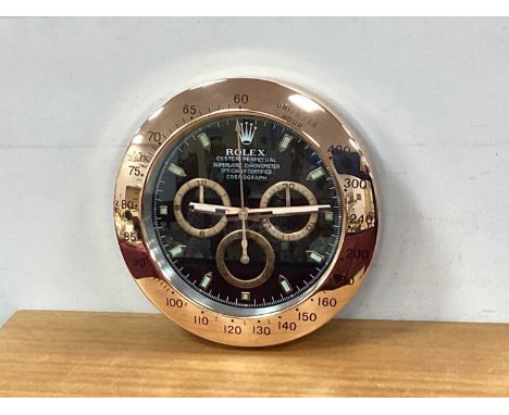'Rolex' Wall Clock 'Oyster Perpetual...' to black dial, in coppered surround 34cm wide, point of sale, not made by Rolex.