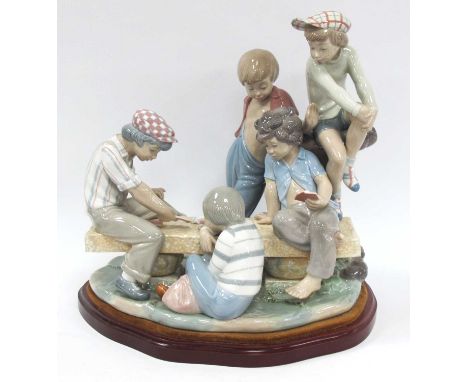 Nao Figure Group of Boys Playing Cards on a Bench, on wooden plinth, 30.5cm high