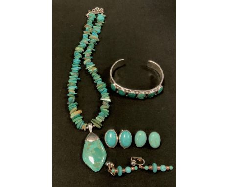 A turquoise inset sterling silver bangle, possibly Native American, stamped Sterling RW;  Thai  pednat necklace;  earrings et