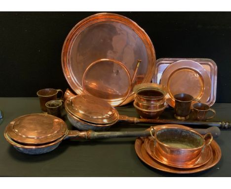 A French copper spiral hunting horn;  large copper circular tray, 51cm diameter;  others smaller, oval planter, warming pans,