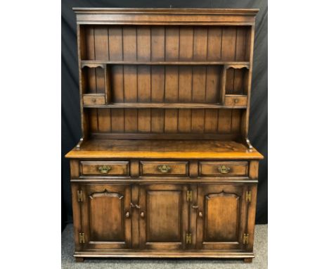 A Titchmarsh and Goodwin oak Dresser, with plate rack top, model RL 19855, 187cm high x 137cm wide x 46cm deep. 