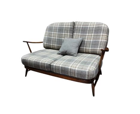 ERCOL FOUR PIECE LOUNGE SUITE, CIRCA 1970s comprising a two seater settee, rocking chair, elbow chair and foot stool, all rec