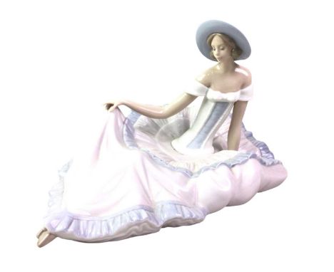 NAO FIGURE OF A LADY, modelled seated wearing a hat, with stamp mark31cm wide