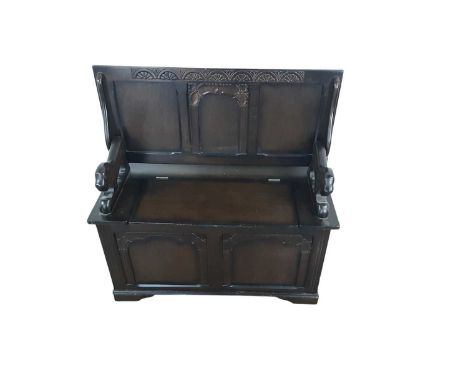 STAINED OAK MONKS BENCH, with lion arms97cm high, 95cm wide