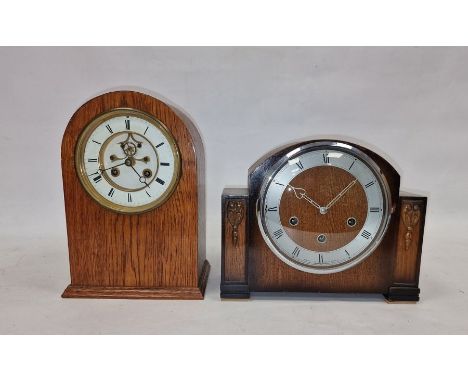 Early 20th century oak cased mantel clock, the circular enamel dial with Roman numerals denoting hours, the case back with be