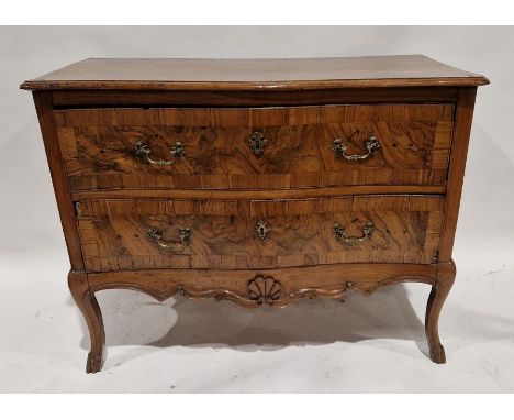 19th century continental walnut commode of serpentine form, having two long drawers each with two ornate brass handles and br