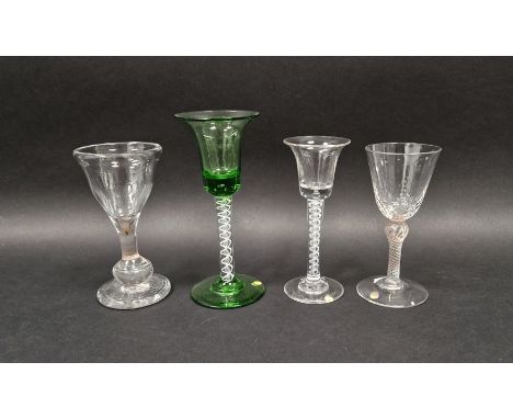 Four drinking glasses, two in the mid 18th century-style, the first with flared bowl and tear inclusions above airtwist stem,