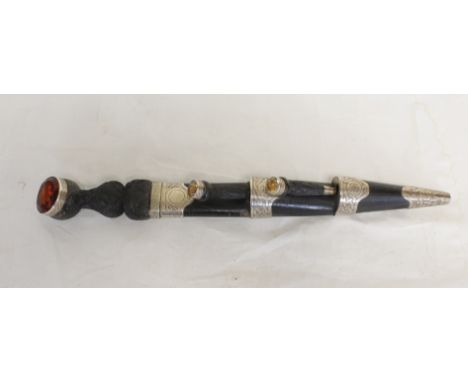Scottish piper's dirk with accompanying knife and fork. Carved ebony handles and citrine paste finials. Silver mounted in bla