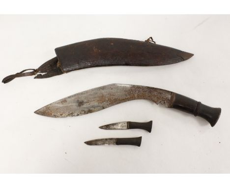Nepalese Kukri knife in curved leather scabbard complete with two smaller blades. 