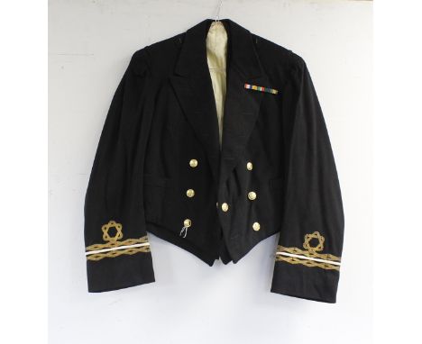 British Royal Navy dress uniform jacket having Gieves Ltd label "4/23 18/D8499 A R Hains", brass naval buttons by Gieves Ltd,