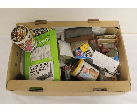 Large box of vintage model railway buildings, station furniture and a tin of miniature people. 