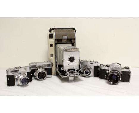 Five vintage cameras to include a 1950's Polaroid 800 land camera, Japanese Miranda SRL with a 50mm F1.9 lens and a Voightlan