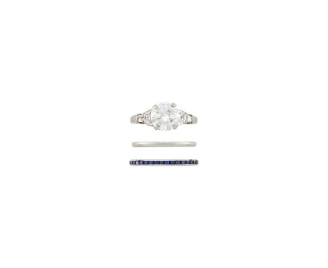One round diamond weighing 2.04 cts., 2 half moon-shaped and 2 tapered baguette diamonds ap. .40 ct., one rectangular-cut sap