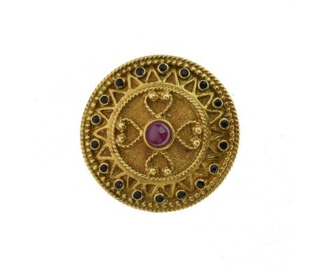 Ruby and sapphire brooch, stamped '750' and 'Greece', of circular outline, with applied wirework decoration, 3.3cm diameter, 