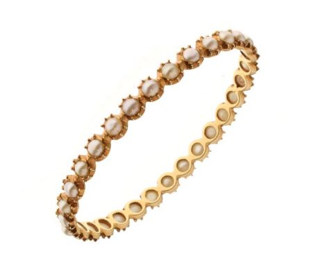 Unmarked yellow metal and pearl bangle, of oval form set thirty-one small pearls within claw-type setting, 20.3g approx gross