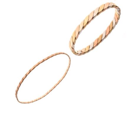 Tricolour hinged bangle, stamped '375', of plaited design, 6mm wide, internal diameter 6.1cm; with a 9ct gold plaited two col