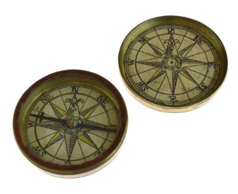 18th Century brass cased pocket compass having a screw cover opening to reveal hand coloured printed panels, 5.25cm diameter 