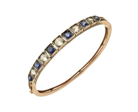 Edwardian diamond and sapphire hinged bangle, unmarked, the frontispiece alternate box set with six graduated sapphires, and 