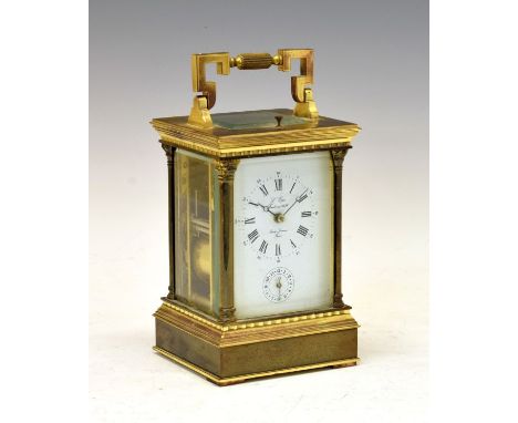 Brass cased carriage clock, the white enamel dial with Roman and Arabic numerals and subsidiary alarm dial, marked to the cen