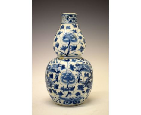 Chinese porcelain double gourd shaped vase having blue and white painted decoration depicting dragons amongst foliage, the un